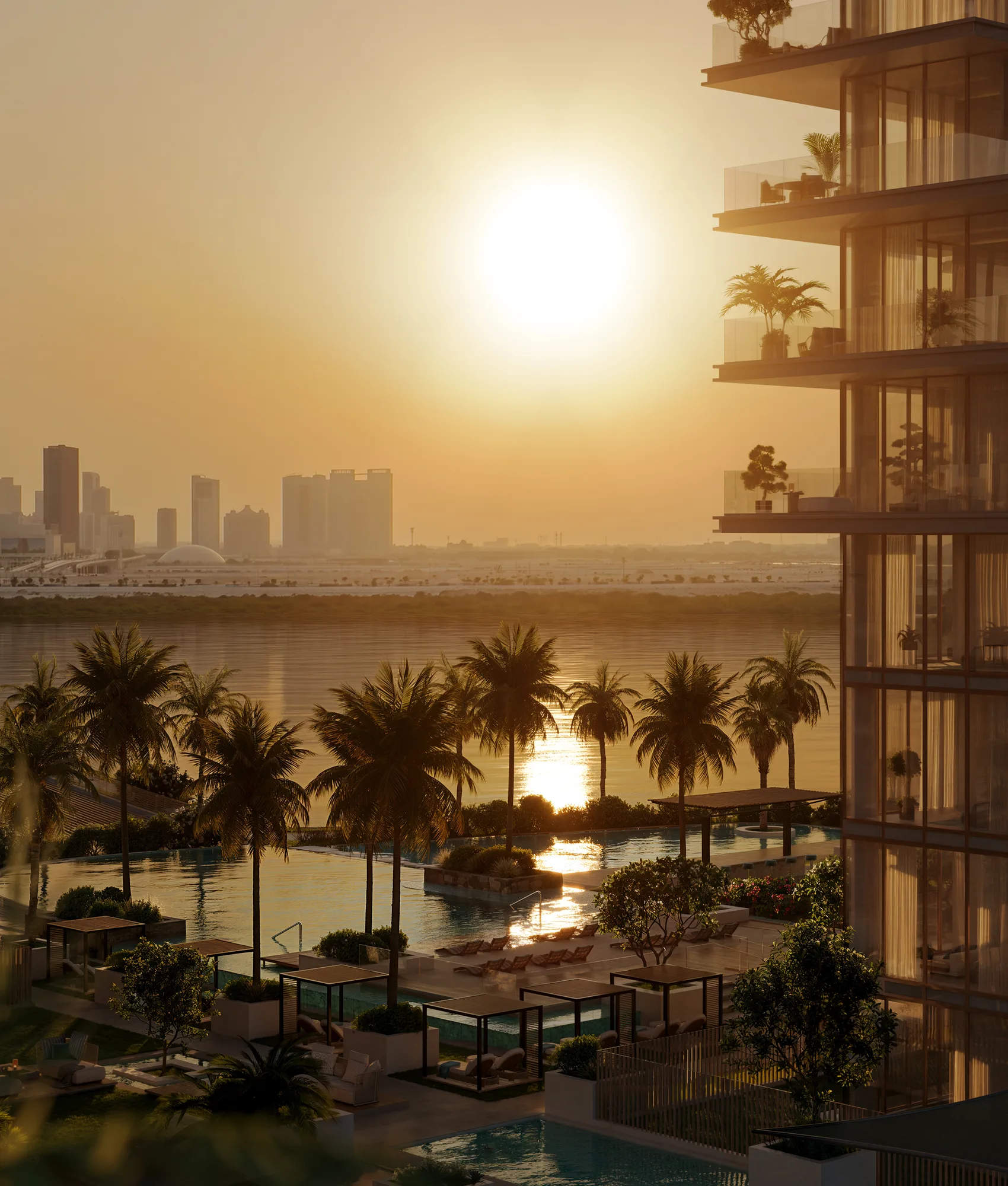 Sunset over the podium pools and cabanas, with the city skyline across the water