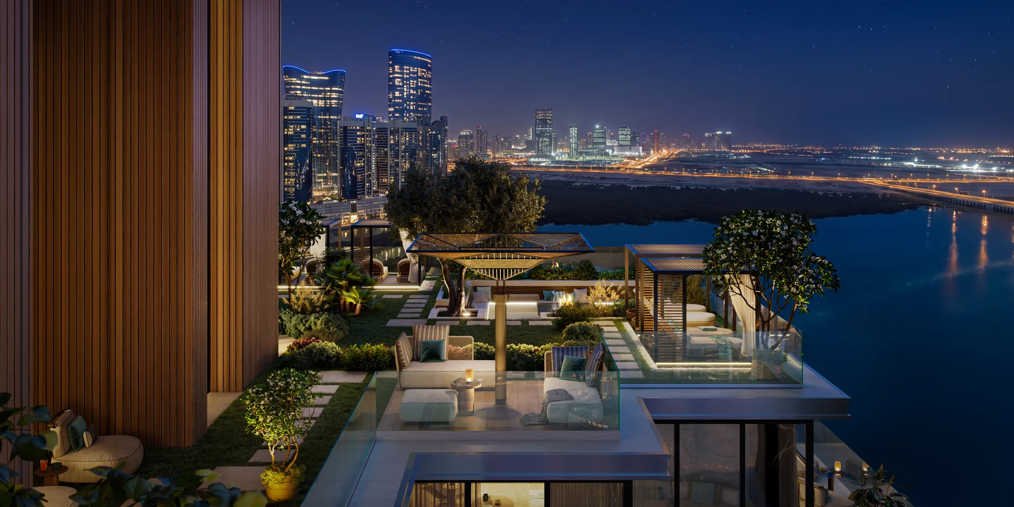 A sky-level outdoor lounge at night: pergola seating, a small pool and the Al Reem Island skyline across the water