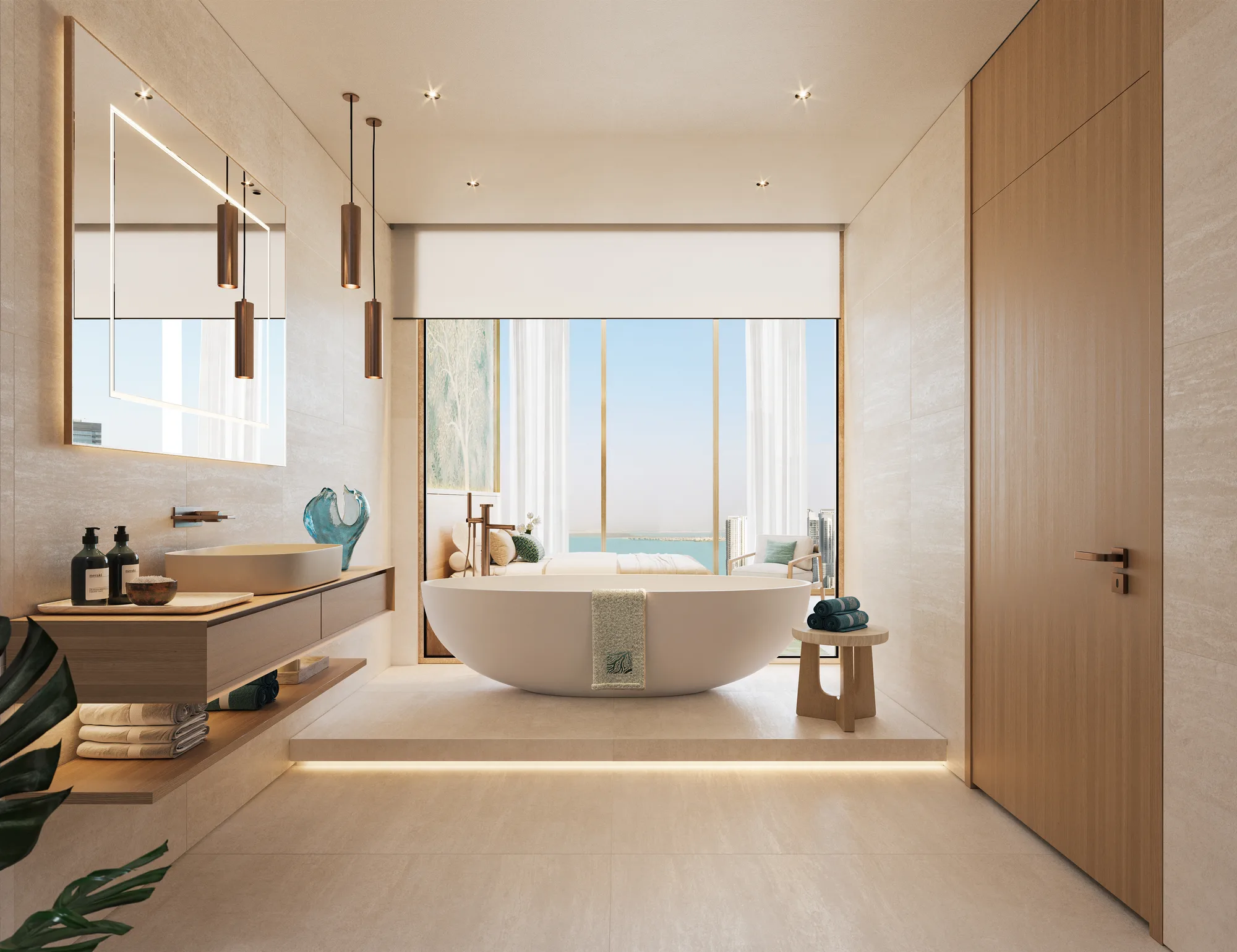 A master bathroom with a freestanding bathtub on a lit plinth, opening onto the bedroom and the sea view