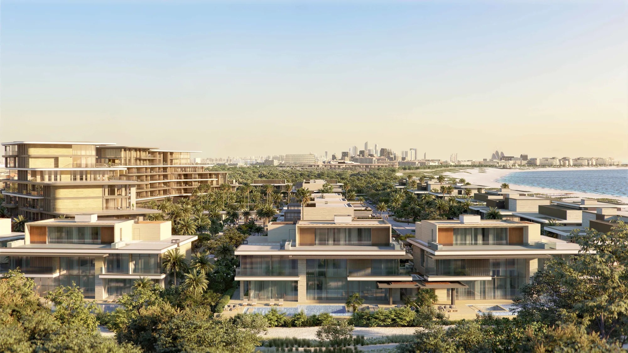 The villas and the curved suites building seen across the gardens towards the beach, the city skyline on the horizon