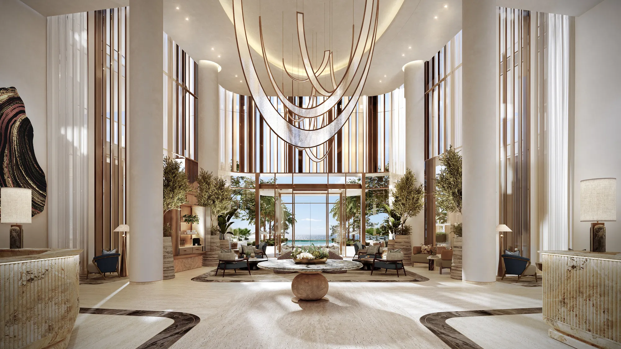 The clubhouse lobby: a double-height hall with a sculptural chandelier, reception desks and the beach beyond