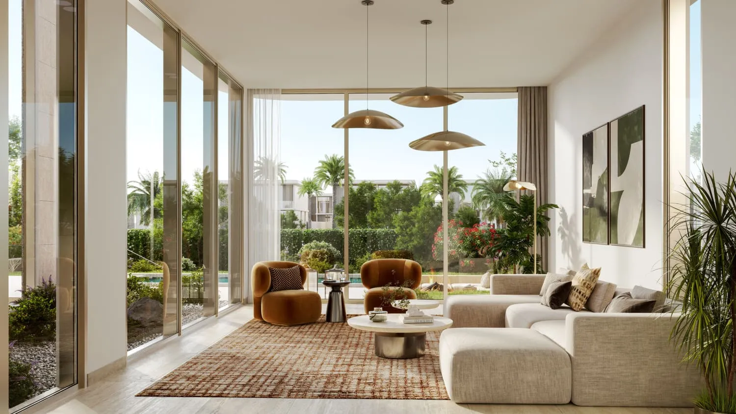 A living room with tall windows: a cream sectional sofa, rust armchairs, two brass pendant lights and a view to the garden
